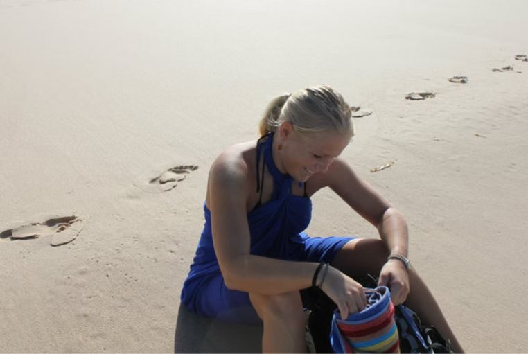 Yvonne Winkler on a peaceful beach, reflecting during her transformational solo travels
