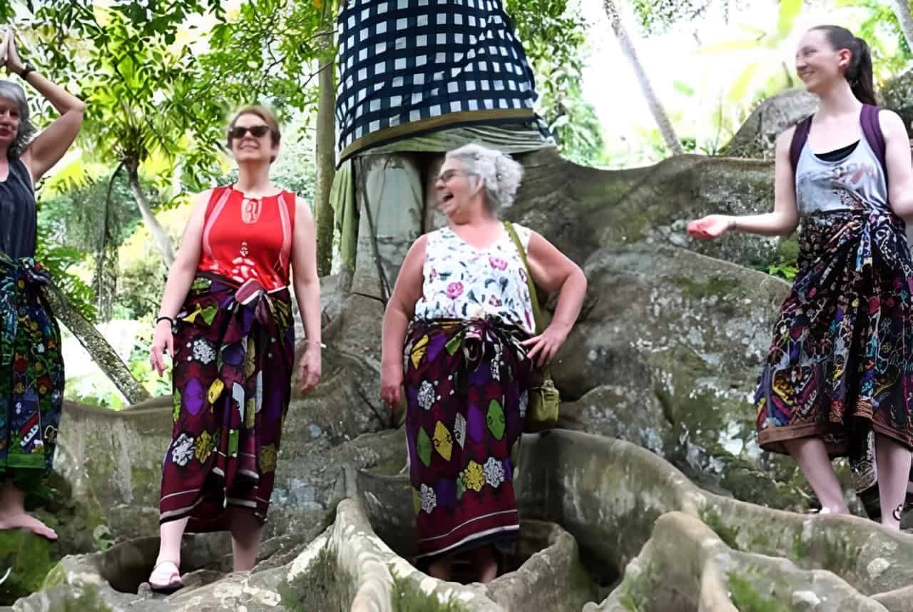 A travel group of women anding in font of a sculpture in Bali - personalized travel experiences for women